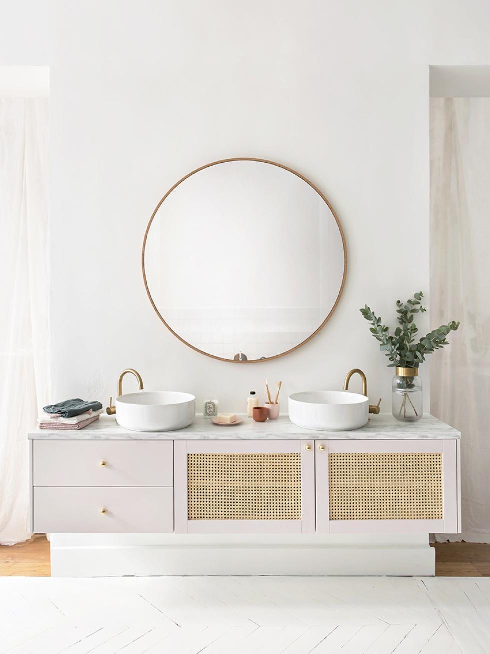 Wall-hung bathroom furniture with wicker fronts and brass accessories.