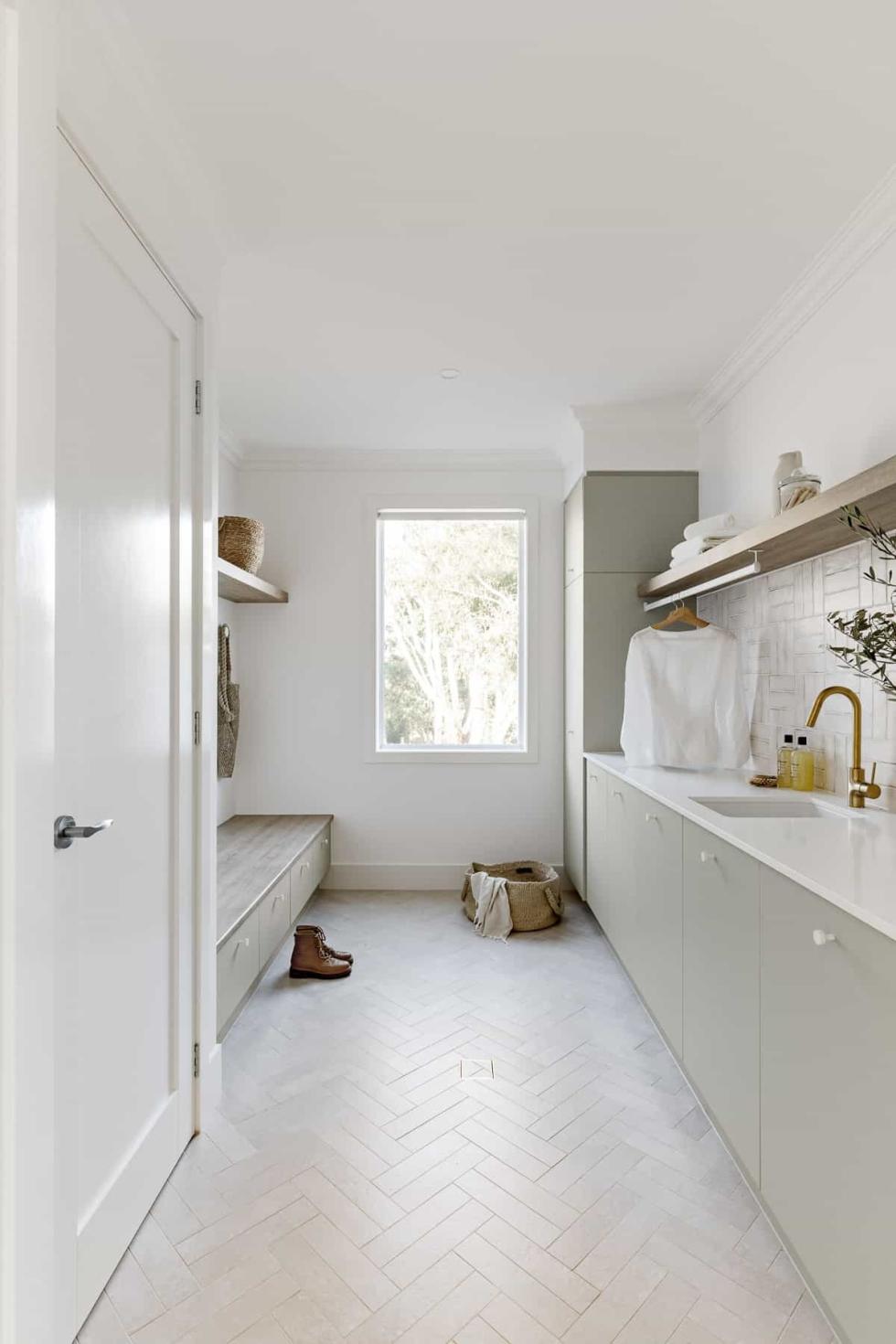 Laundry room with storage and bench