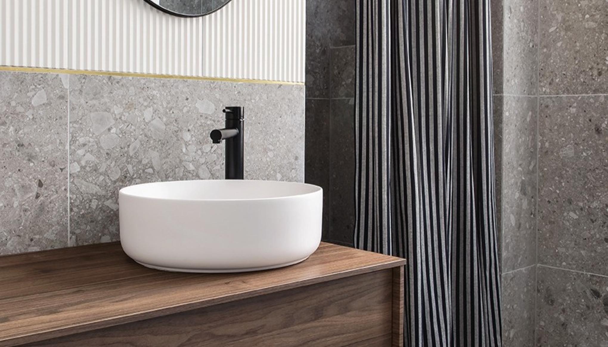 Hanging walnut bathroom cabinet with terrazzo tiles