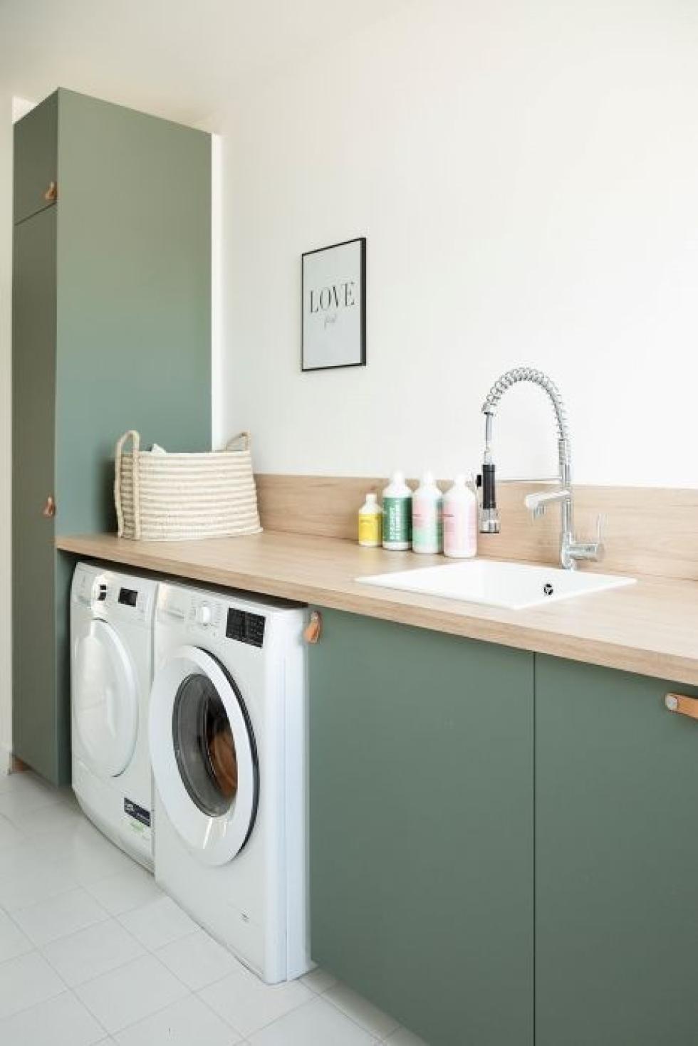 Vert de gris laundry room with washing machines and storage